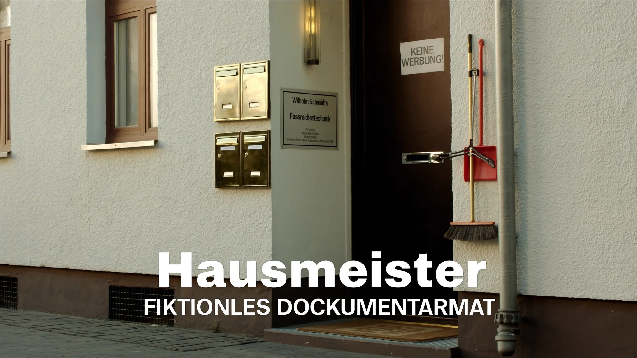 Hauseingang mit Briefkästen und Besen